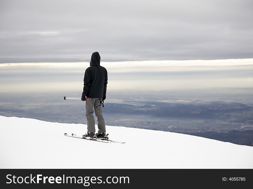 A lone skier on a empty ski slope