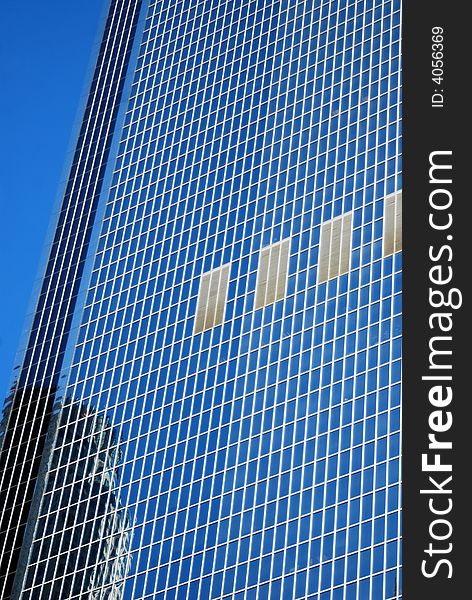 Abstract blue background of modern glass building on a clear sunny day. Abstract blue background of modern glass building on a clear sunny day.