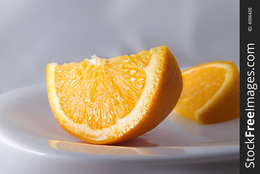 Juicy orange on a white plate. Juicy orange on a white plate