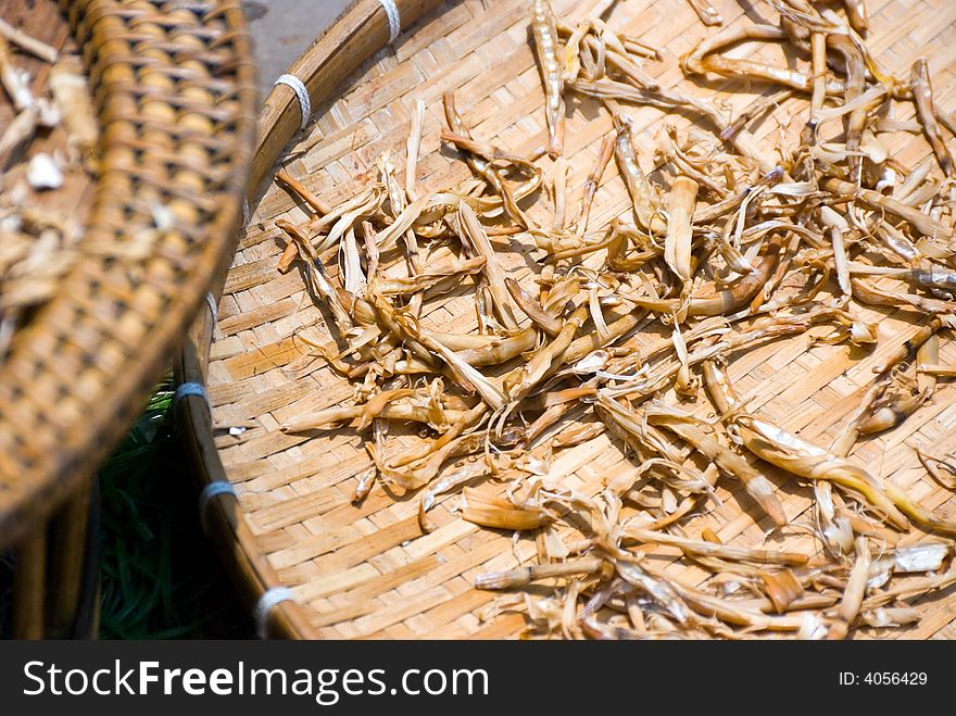 Mysterious spices being dried up in the sun on bamboo platforms