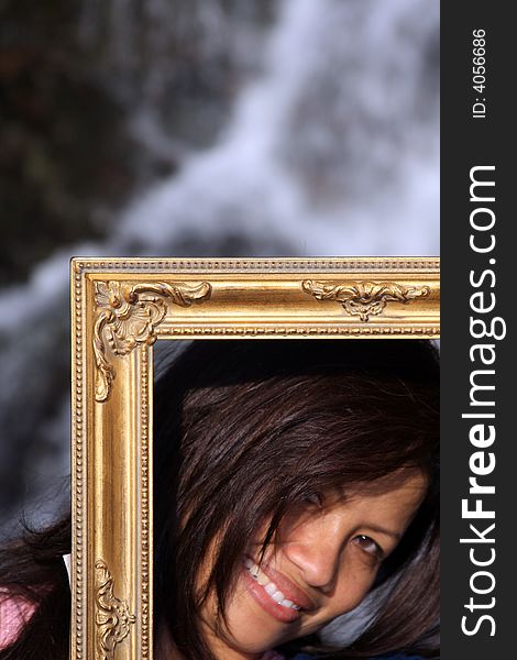 Portrait using a frame and waterfall as background. Portrait using a frame and waterfall as background