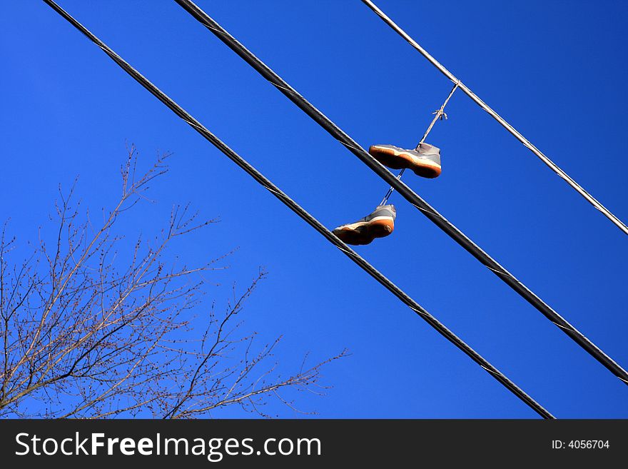 Hanging shoes on electrical wire. Hanging shoes on electrical wire