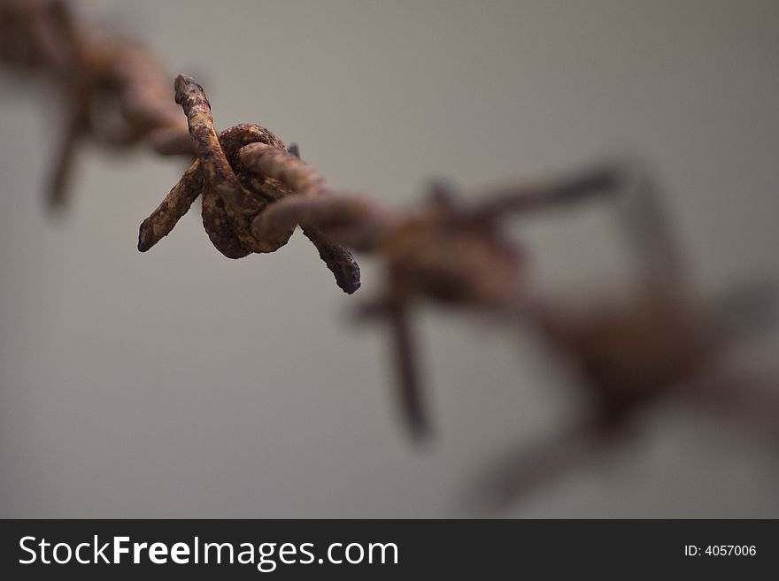 Close up shot of an old rusty barbed wire