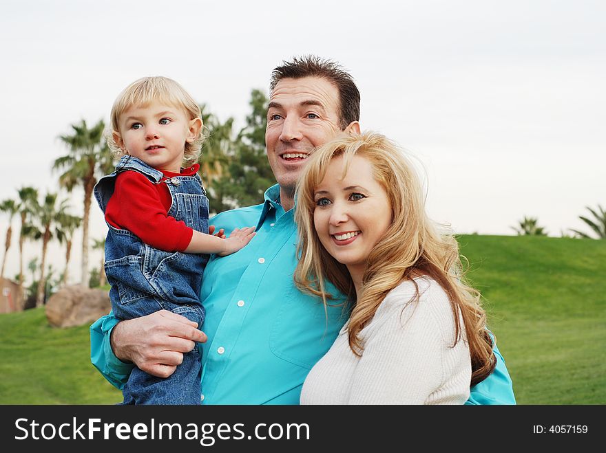 Happy couple with a child smiling and enjoying their time together