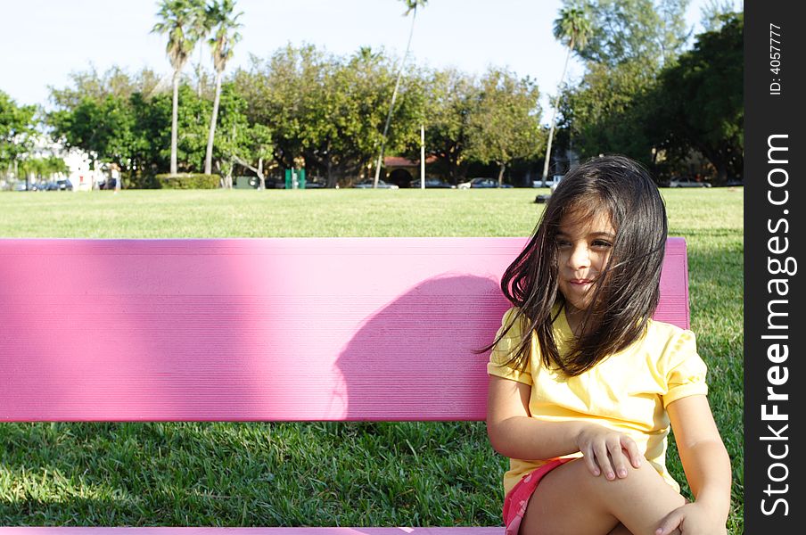 Girl Sitting on a park bench. Girl Sitting on a park bench.