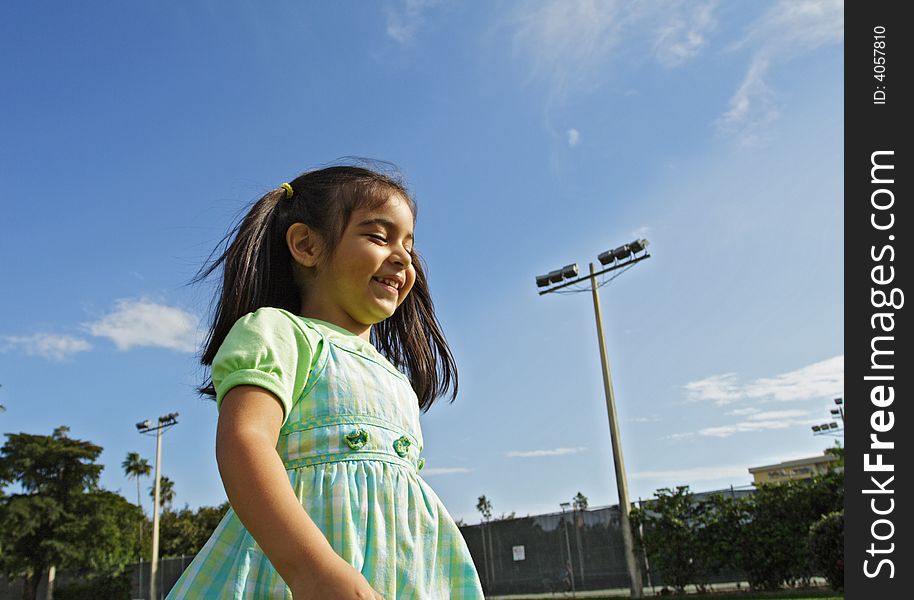 Girl Walking through a park. Blue sky background. Girl Walking through a park. Blue sky background