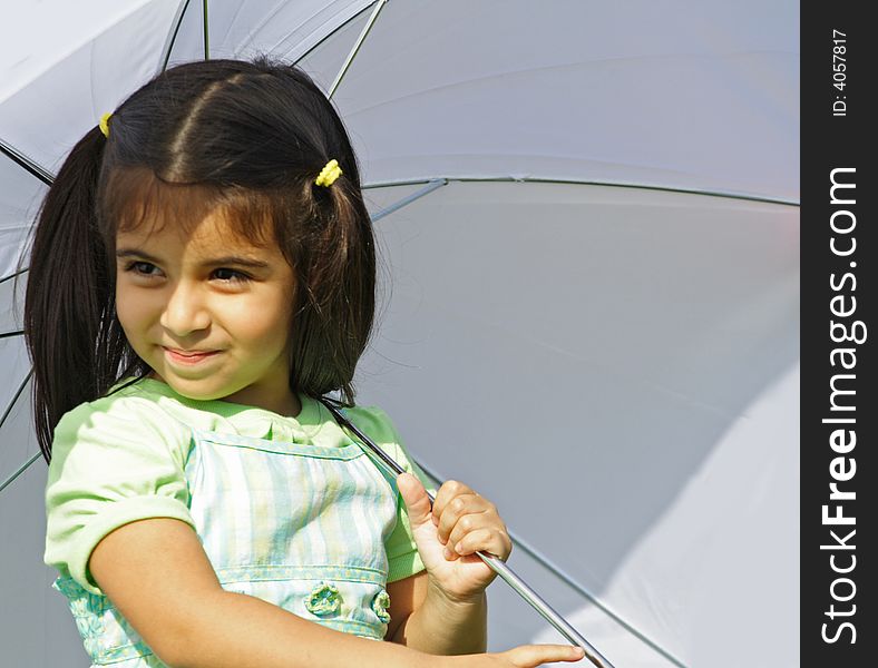 Girl underneath an umbrella with copy space. Girl underneath an umbrella with copy space