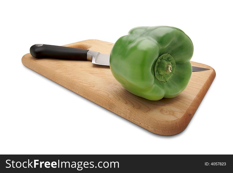 Green Bell Pepper and Knife on a Wood Cutting Board