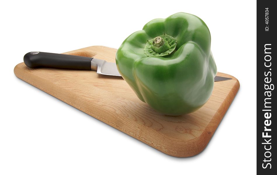 Green Bell Pepper and Knife on a Wood Cutting Board
