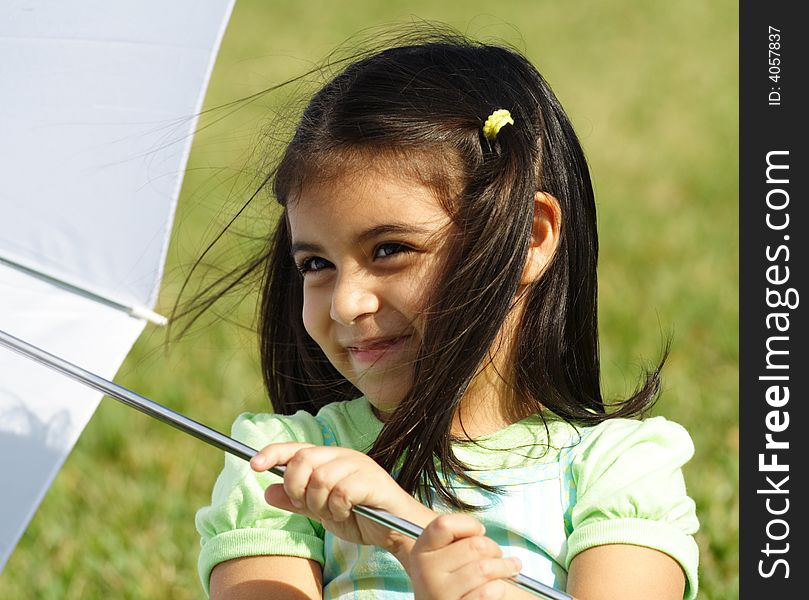 Little girl playing with a white umbrella. Little girl playing with a white umbrella