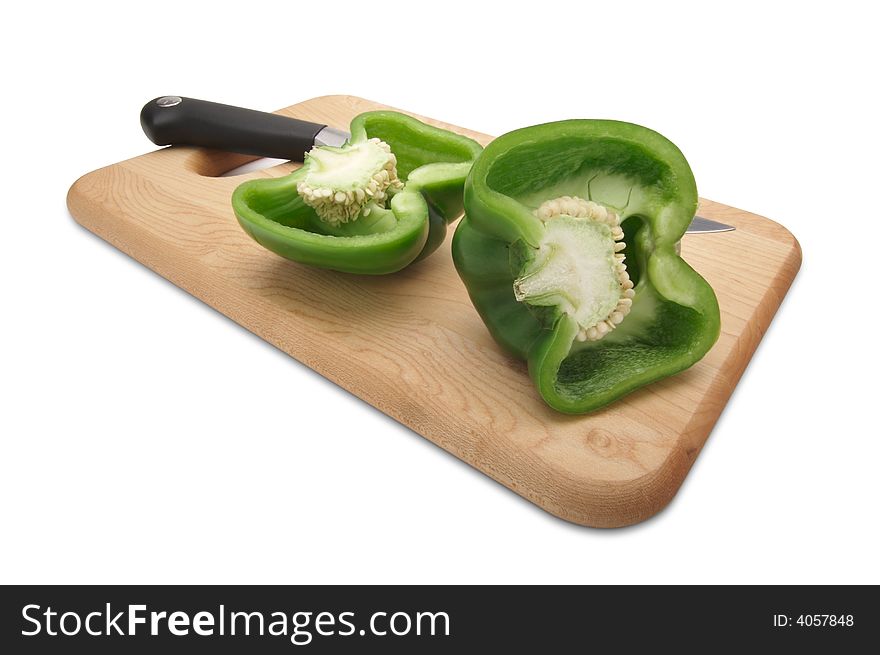 Cut Green Bell Pepper and Knife on a Wood Cutting Board