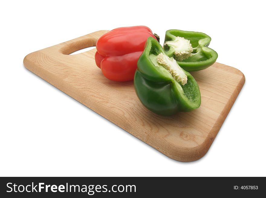 Green and Red Bell Peppers and Knife on a Wood Cutting Board