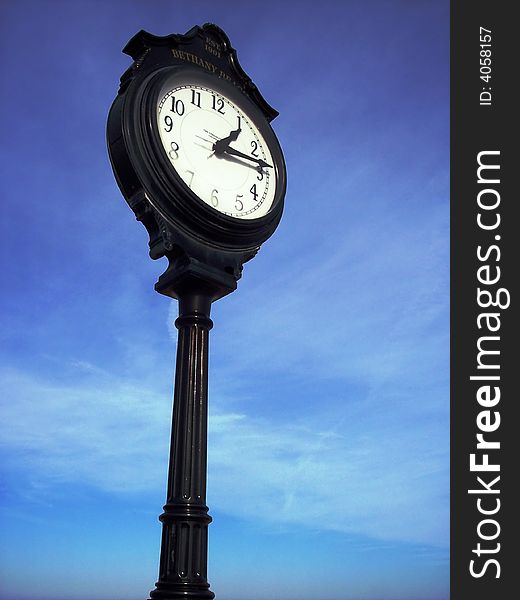 Black Antique clock against a blue sky. Black Antique clock against a blue sky