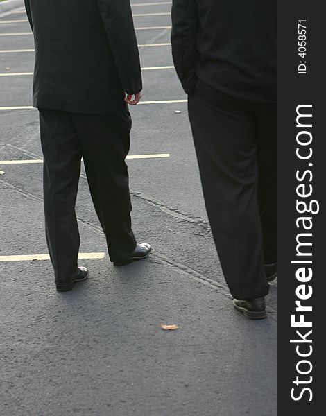 Two business men walking in parking lot. Two business men walking in parking lot