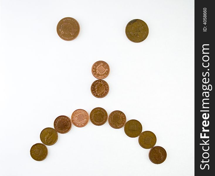 Simple 'sad' emoticol symbol made of one penny coins. Simple 'sad' emoticol symbol made of one penny coins