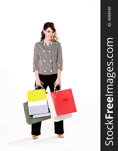 Young woman happily shopping full of paper bags. Young woman happily shopping full of paper bags