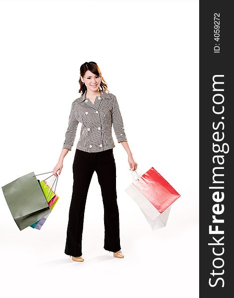 Young woman happily shopping full of paper bags. Young woman happily shopping full of paper bags