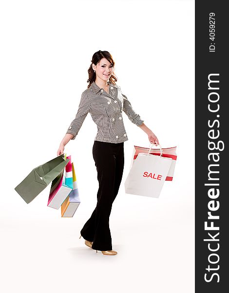 Young woman happily shopping full of paper bags. Young woman happily shopping full of paper bags