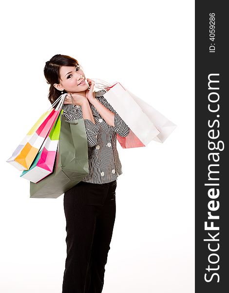 Young woman happily shopping full of paper bags. Young woman happily shopping full of paper bags