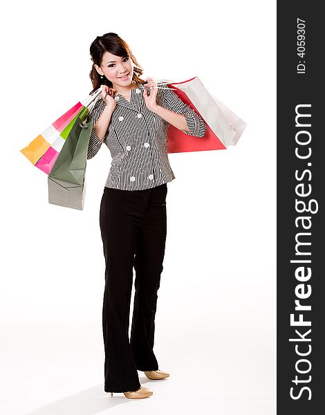 Young woman happily shopping full of paper bags. Young woman happily shopping full of paper bags