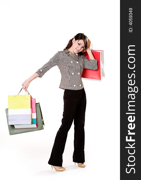 Young woman happily shopping full of paper bags. Young woman happily shopping full of paper bags