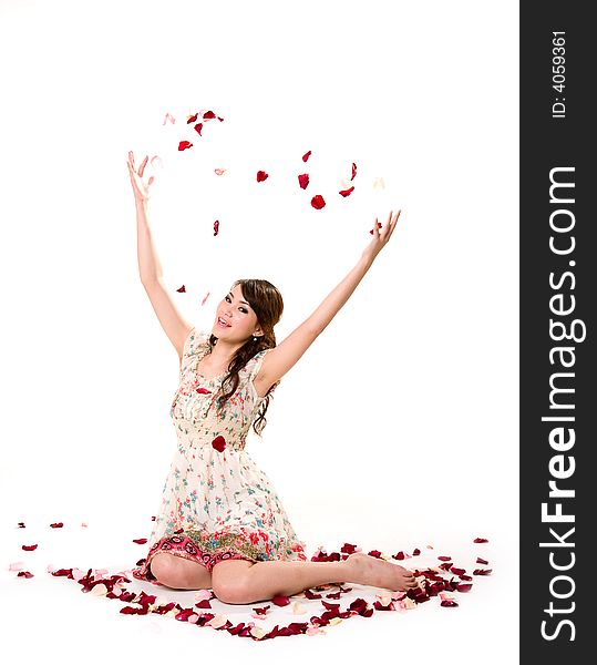 A very happy and joyfull girl tossing rose petals in the air. A very happy and joyfull girl tossing rose petals in the air