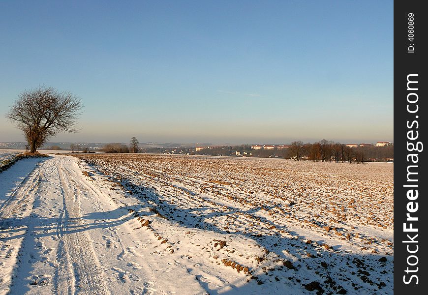 An view over an field with some snow on an cold december morning. An view over an field with some snow on an cold december morning.