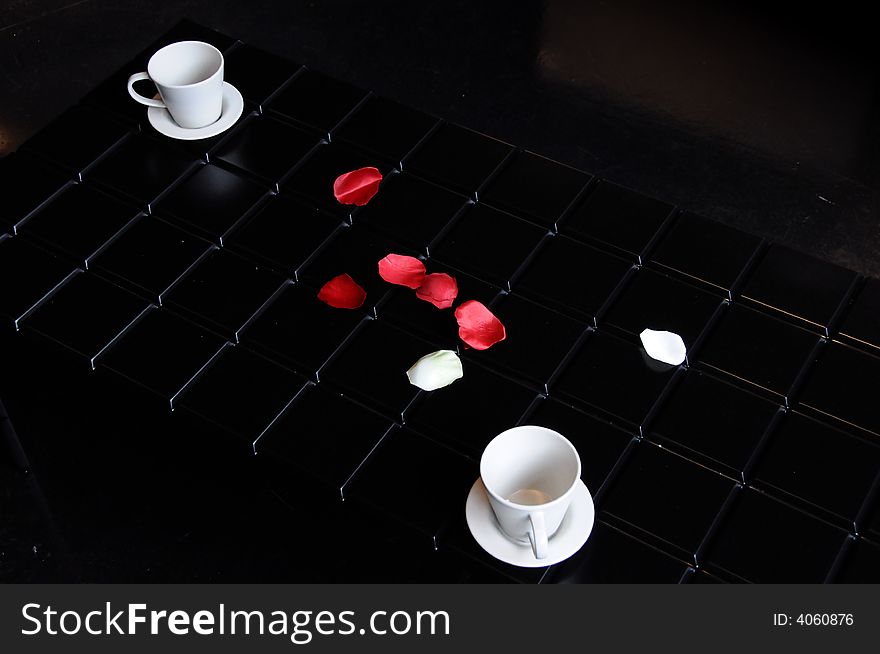 Cups On Table With Red Flowers