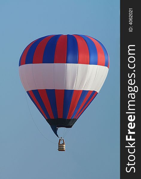 Red, white and blue, un-manned hot-air balloon flying.