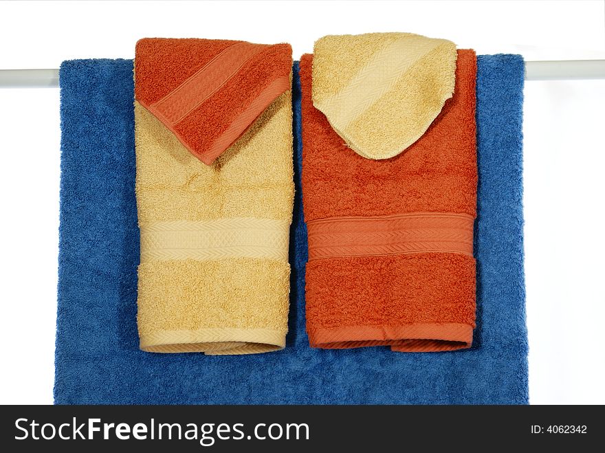 Colorful fluffy towel and wash clothes arranged decoratively. Colorful fluffy towel and wash clothes arranged decoratively.