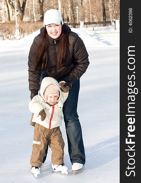 Mother and child on the ice rink