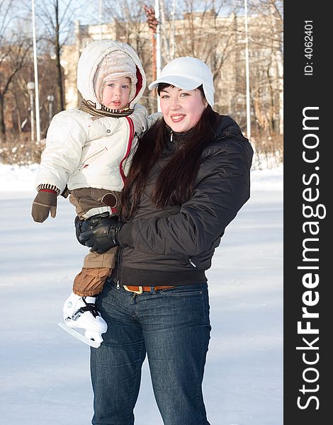 Mother and child on the ice rink
