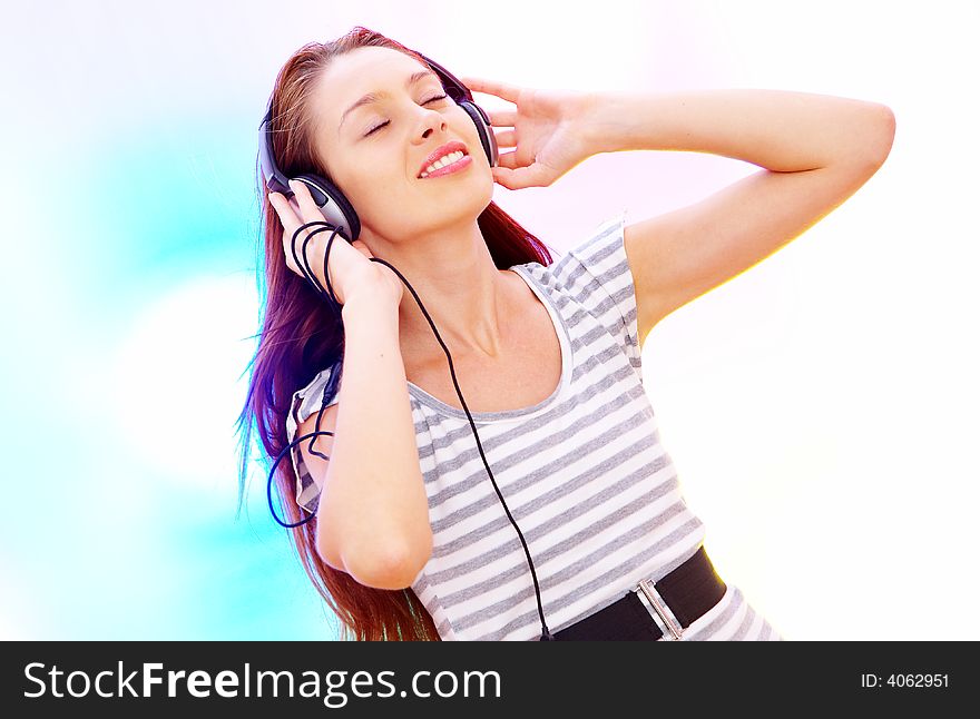 View of young  female listening music via earphones. Image may contain slight multicolor aberration as a part of design. View of young  female listening music via earphones. Image may contain slight multicolor aberration as a part of design.