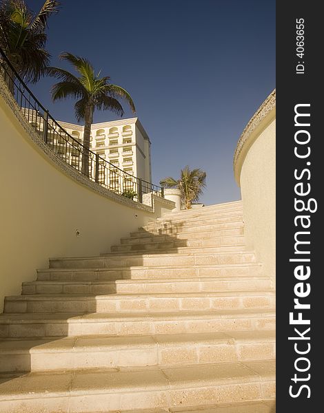 Steps leading up from the beach to a luxury resort. Steps leading up from the beach to a luxury resort