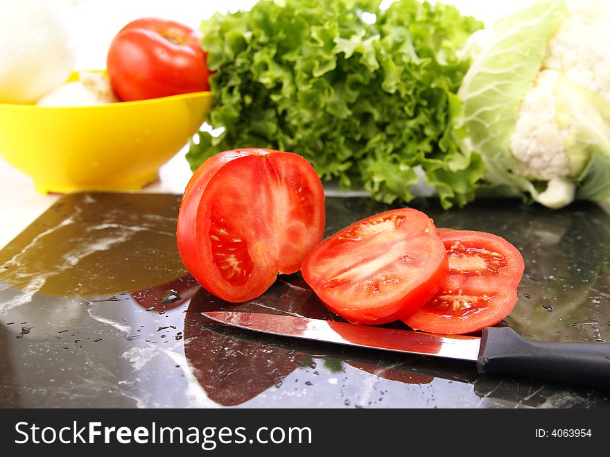 Fresh sliced ripe tomatoes on black marble cutting board. Fresh sliced ripe tomatoes on black marble cutting board.