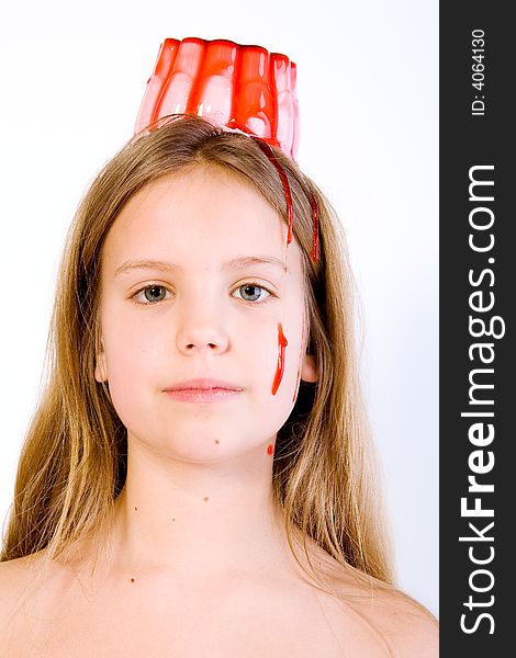 Blond child with desert on her head looking