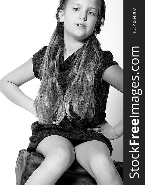 Studio portrait of a blond child sitting and posing. Studio portrait of a blond child sitting and posing