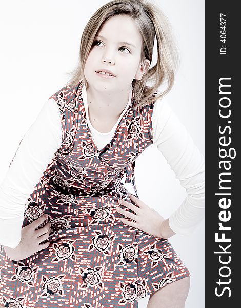 Studio portrait of a blond child looking up fashionably
