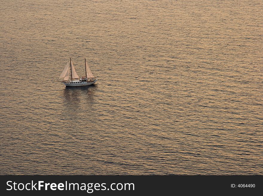 Beatifull Yaht in Aegean Sea  at famous Santorini Sunset. Beatifull Yaht in Aegean Sea  at famous Santorini Sunset