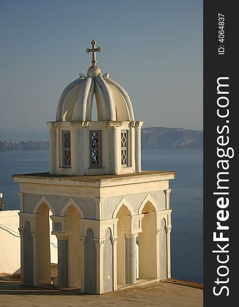 Church with cross at Santorini, Greece with bay in background. Church with cross at Santorini, Greece with bay in background