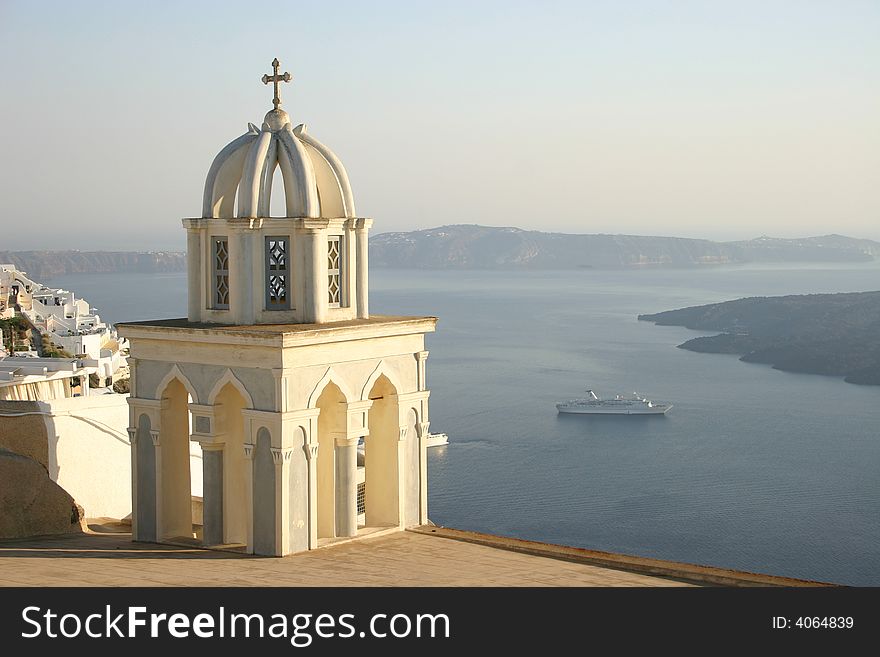 Church with cross at Santorini, Greece with bay in background with cruise ship. Church with cross at Santorini, Greece with bay in background with cruise ship