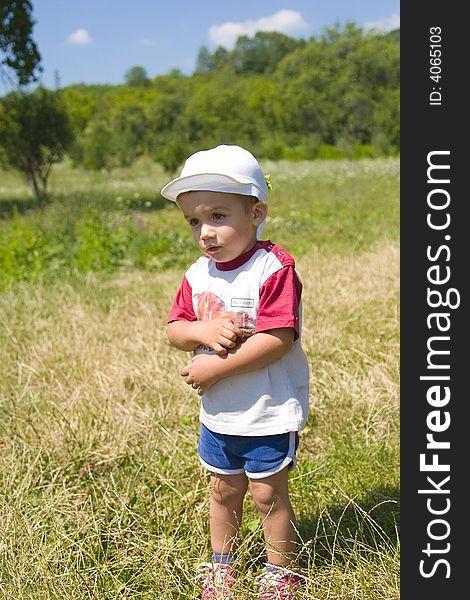 Cute child standing in a garden. Cute child standing in a garden