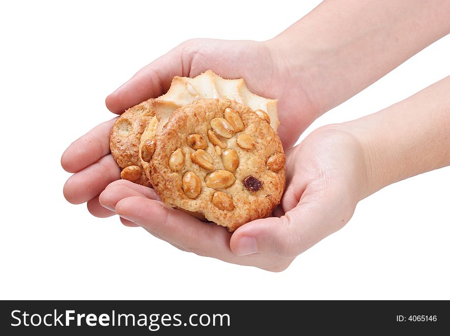 Hands offering assorted cookies on isolated white background. Hands offering assorted cookies on isolated white background.