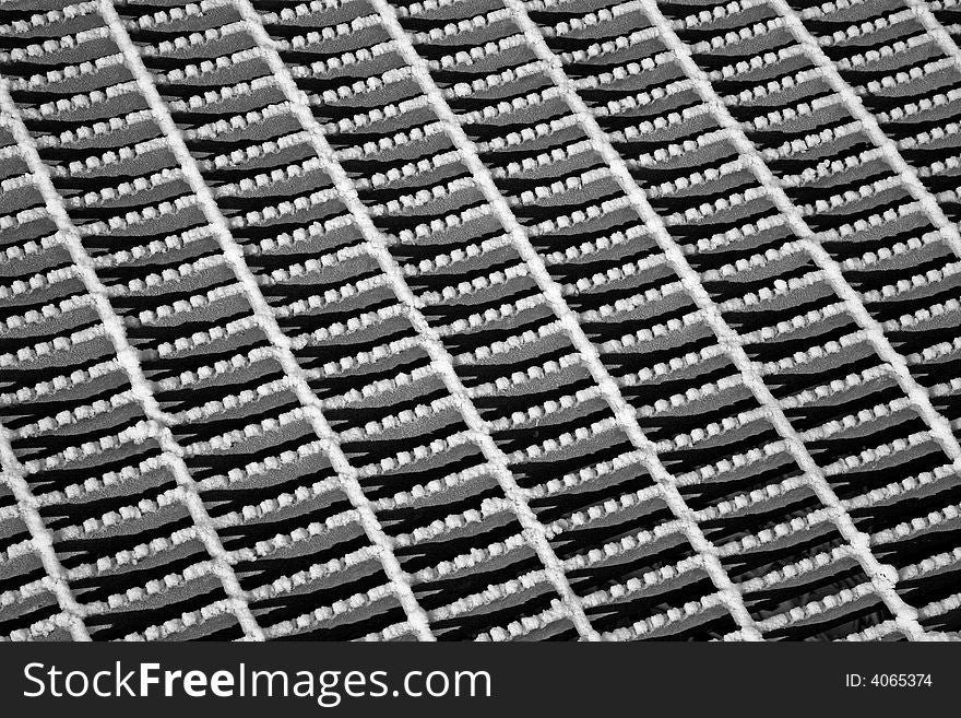 Steel grate with snow in an abstract pattern