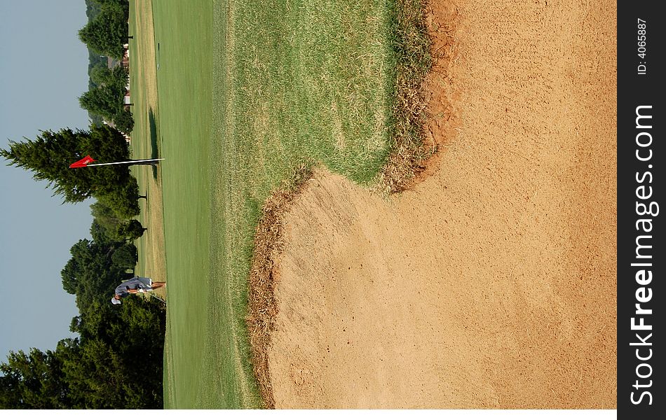 Putting Near Sand trap on golf course