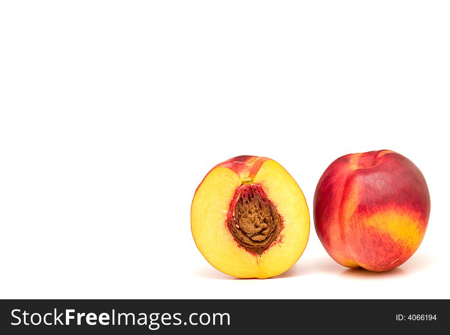 Two peaches isolated on white, one cut in health. Two peaches isolated on white, one cut in health