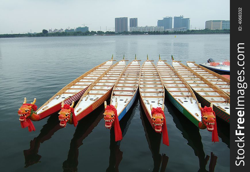 Dragon boats and buildings in a park