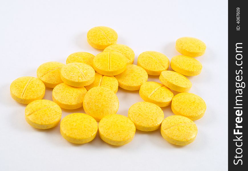 Pile of yellow vitamin tablets. Pile of yellow vitamin tablets