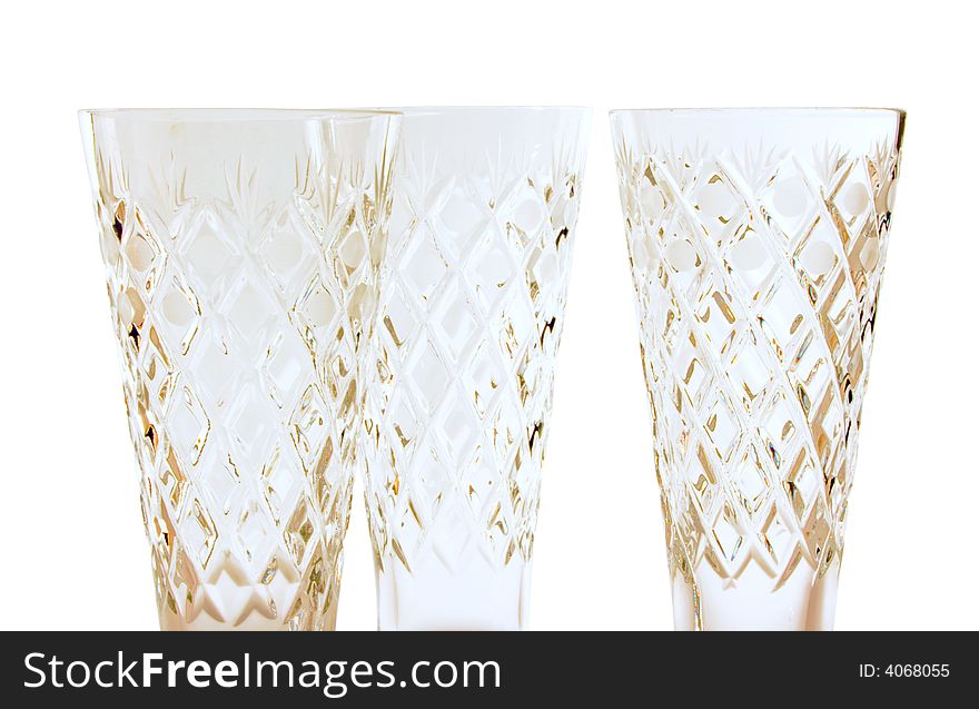A glass beside a stack of white plates - on white background. A glass beside a stack of white plates - on white background