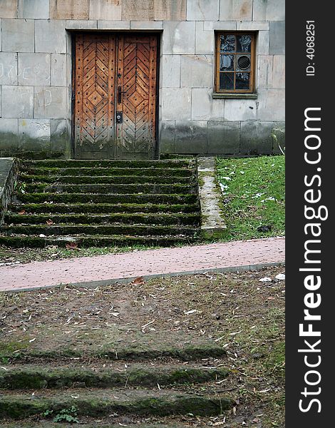 Dirty stairs covered with moss, old wooden door,. Dirty stairs covered with moss, old wooden door,